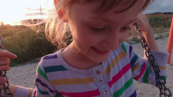 Father Swings Girl On Swing alt