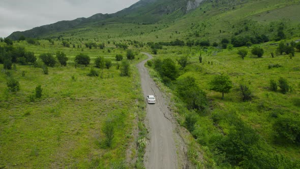 Car driving on road near green mountains