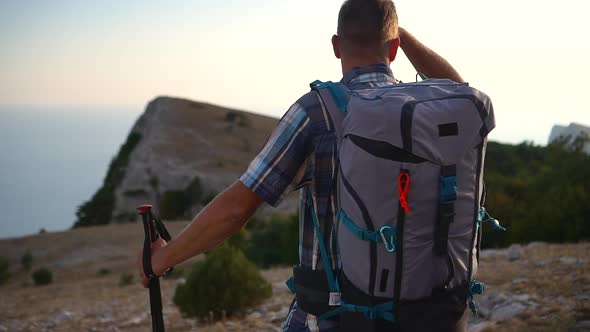 Young Athlete Standing on Mountain and Looking at Seascapes While Hiking on Autumn Spbd