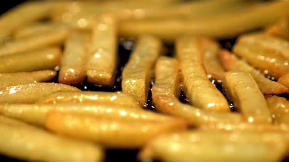 Super Slow Motion of Fries is Fried in a Frying Pan with Bubbles of Oil