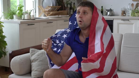 Male Sports Fan at Home with USA Flag