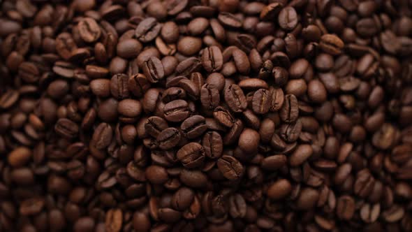 Dark roast coffee beans top view, rotate