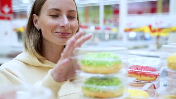 Woman Buying Donuts In The Pastry Section