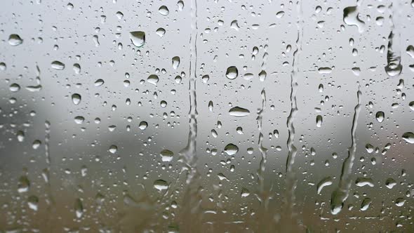Window with Raindrops During the Rain. Slow Motion Shot