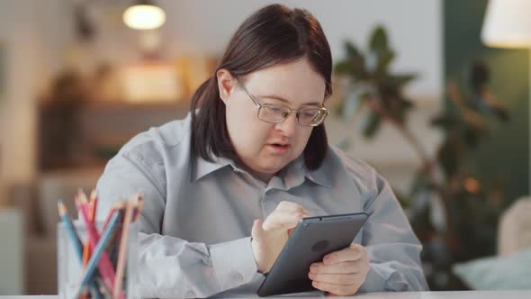 Man with Down Syndrome Using Tablet at Home