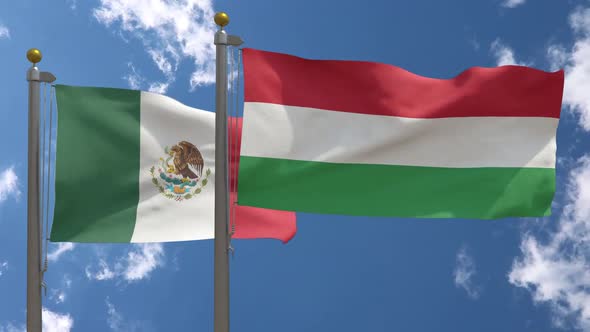 Mexico Flag Vs Hungary Flag On Flagpole