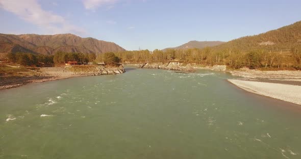 Low Altitude Flight Over Fresh Fast Mountain River with Rocks at Sunny Summer Morning