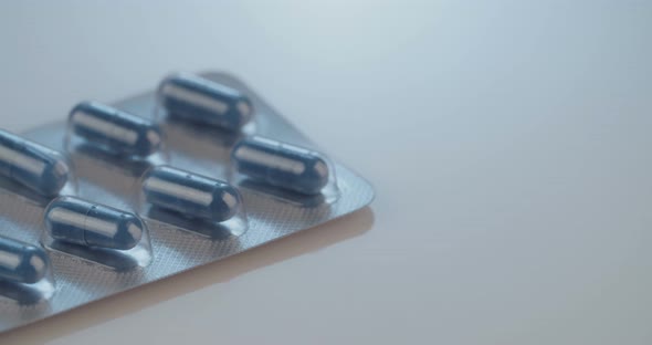 Prescription drugs - Capsules, pills, tablets on reflective background