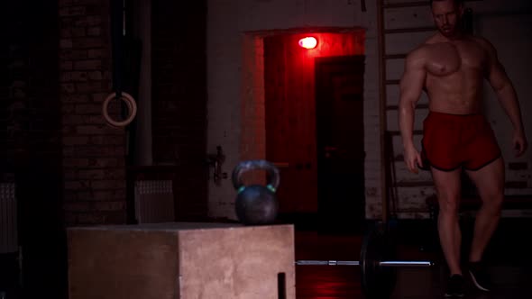 Tough Man Covered in Sweat Walks in the Gym and Sits on the Square Stool