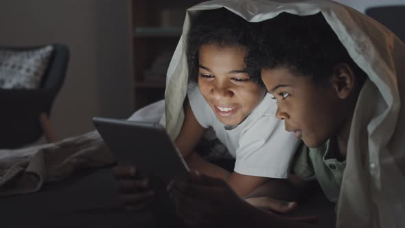 Kids Using Tablet in Bed