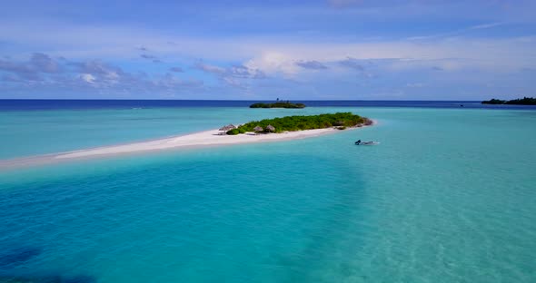 Natural fly over copy space shot of a white sand paradise beach and blue sea background in vibrant 4