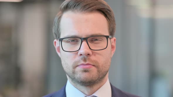 Face Close up of Businessman Looking at Camera