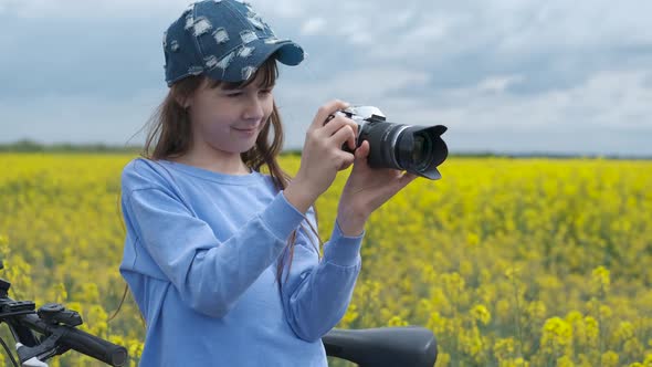 Little girl with a camera on a bike. 