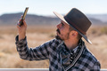 Cowboy with grey hat, moustache and checked shirt taking a selfie - PhotoDune Item for Sale