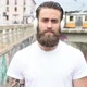slow motion portrait young beautiful bearded man outdoor listening music looking camera - VideoHive Item for Sale