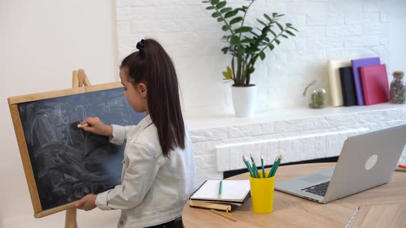 Little School Girl Writing Letters on Blackboard