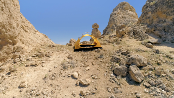 Aerial  Shot Through the Isolated Terrain with Blue Sky in the Background