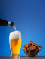 Salty rye crackers and beer pouring into glass - PhotoDune Item for Sale