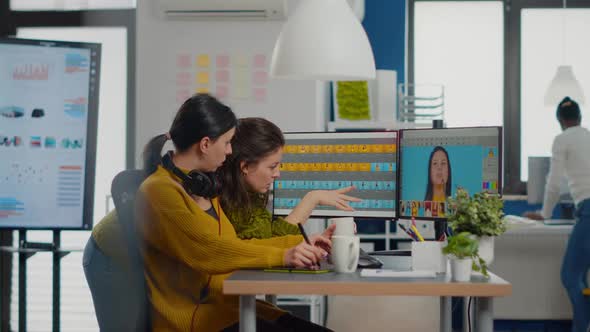 Confident Women Photo Editors Sitting at Workplace in Creative Studio