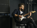 Bearded man playing guitar in a music studio - PhotoDune Item for Sale
