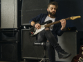 Bearded man playing an electric guitar in a studio - PhotoDune Item for Sale