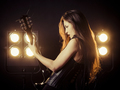 Sexy woman playing electric guitar on stage - PhotoDune Item for Sale