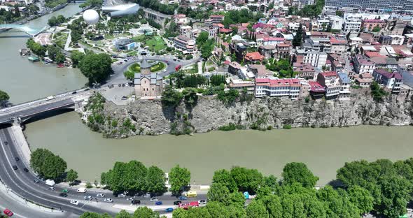 Aerial view of Metekhi church in old Tbilisi located on cliff near river Kura