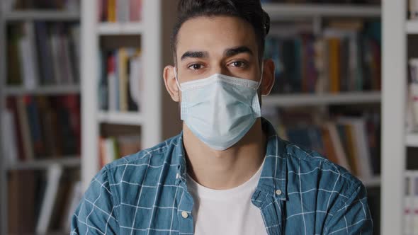 Closeup Serious Pensive Young Man Sitting Indoors Alone Wearing Protective Surgical Mask Hispanic