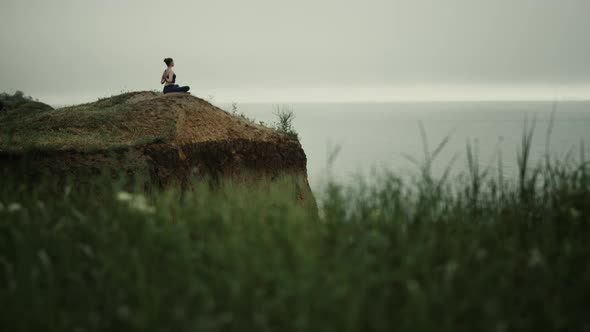 Far View Yoga Woman Exercising on Hill Top