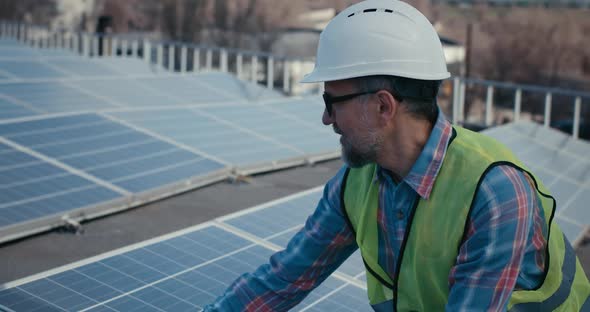 Technician Talking To Someone Before Solar Panels