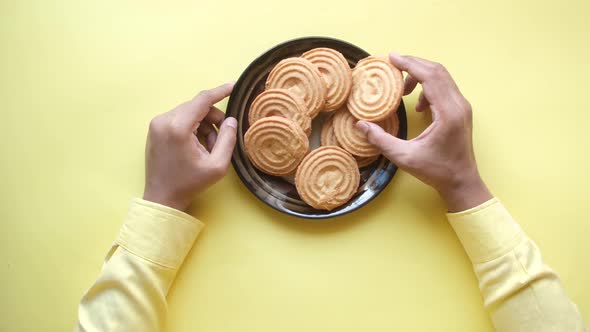 Hand Pick Sweet Cookies on Wooden Table