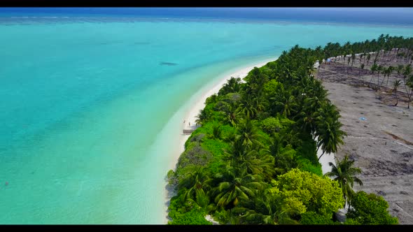 Aerial texture of idyllic tourist beach vacation by blue green lagoon with white sandy background of