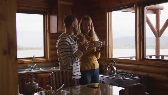 Caucasian couple spending time at home together, drinking a beverage