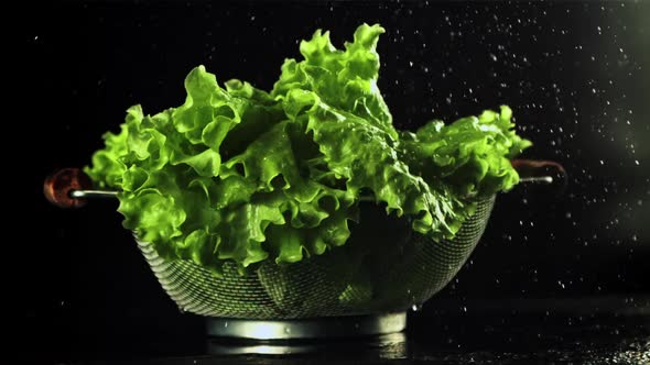 Water Falls on the Lettuce Leaves in a Colander