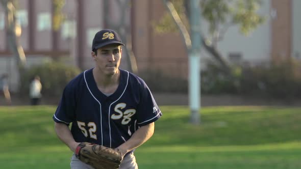 A young man playing catch with a baseball.