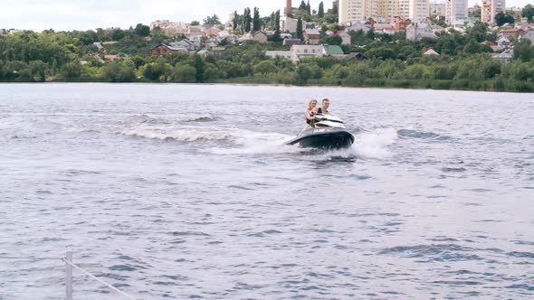 Holiday Couples Ride a Jet Ski