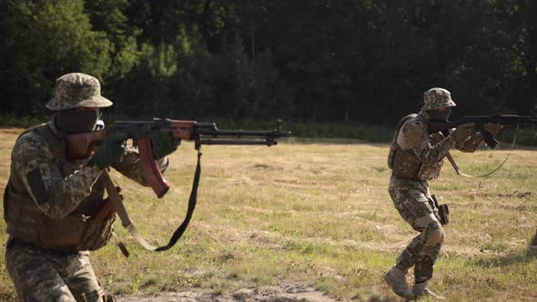 Soldiers with Weapons and Ammunition are Attacking the Enemy on Battlefield Military Special Forces