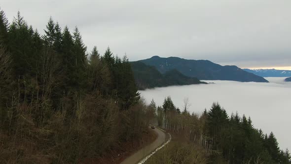 Aerial View of Canadian Mountain Landscape Covered in Fog Over Harrison Lake