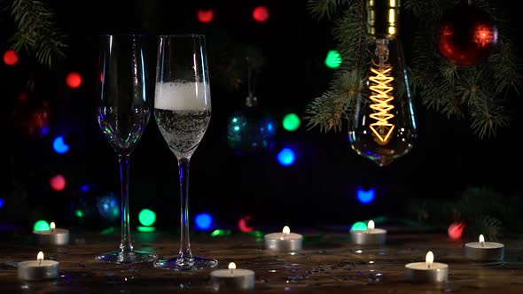 Two Glasses Are Pouring Champagne on the Table Are Lit Light Bulbs a Festive Atmosphere.