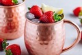 Refreshing iced Moscow mule alcoholic cocktail in copper mugs with strawberry and lemon - PhotoDune Item for Sale