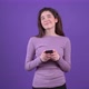 The Charismatic Young Woman Writes a Message on the Phone Concentrated and with a Smile in Love - VideoHive Item for Sale