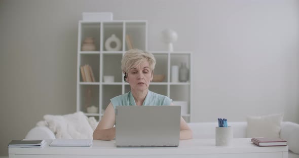 Serious Woman Is Talking By Videocall on Laptop, Teacher Is Communicating with Student Online