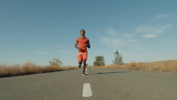 Athlete Runs Along the Road