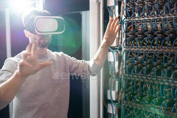 goggles standing in database center and gesturing hands while managing server links wirelessly