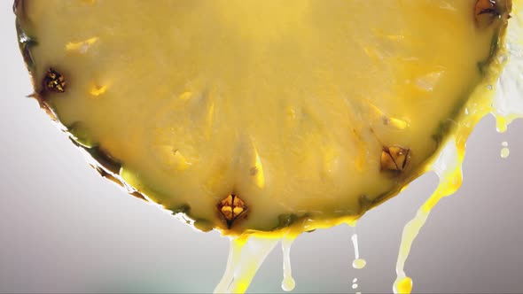 Flowing Pineapple Juice From Pineapple Slice Macro Shot in Slow Motion