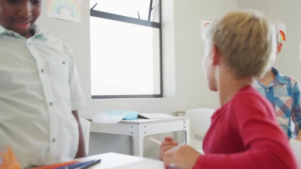 Video of happy diverse boys doing school project together