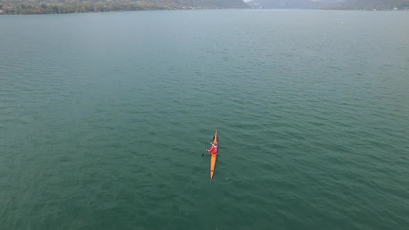 A kayaker paddles in a scenic mountain lake.