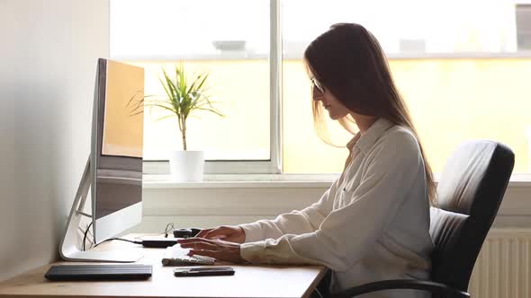 Young woman at work, home office situation