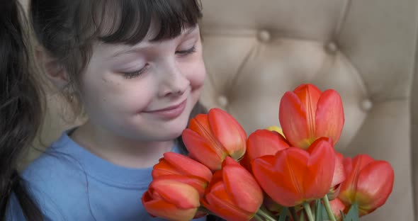 Happy child with tulips. 