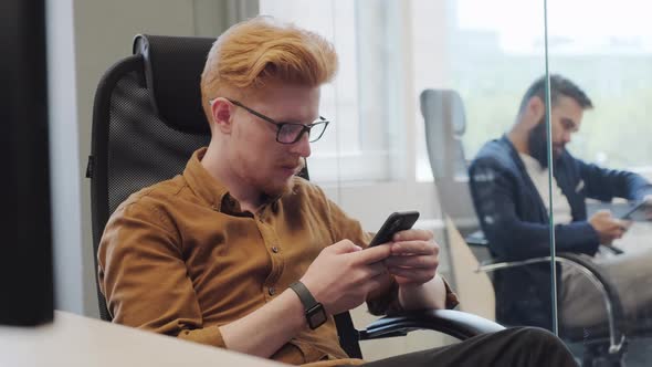 Businessmen Using Smartphones At Work